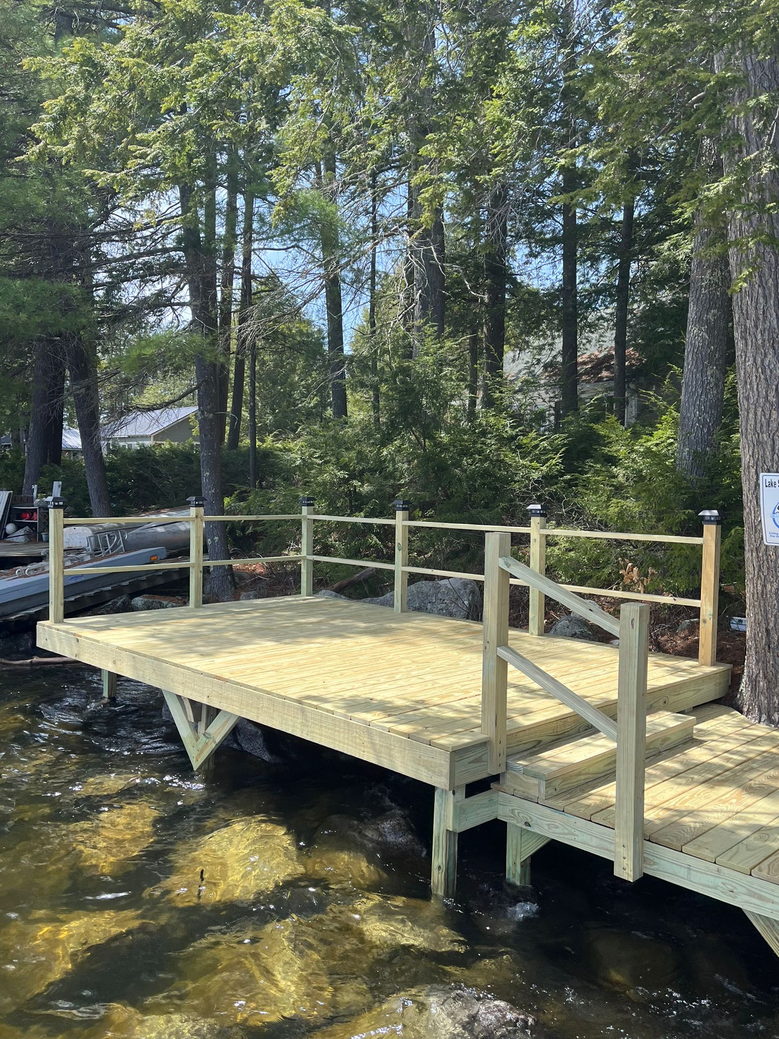 Waterfront dock with wooden railings and clear water views