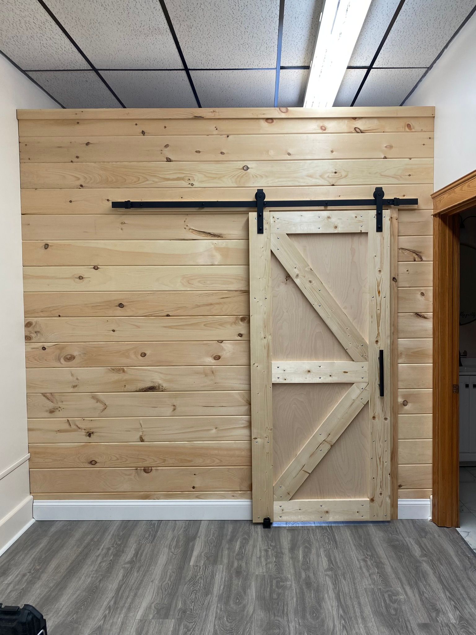 Barn door installation with shiplap wall feature