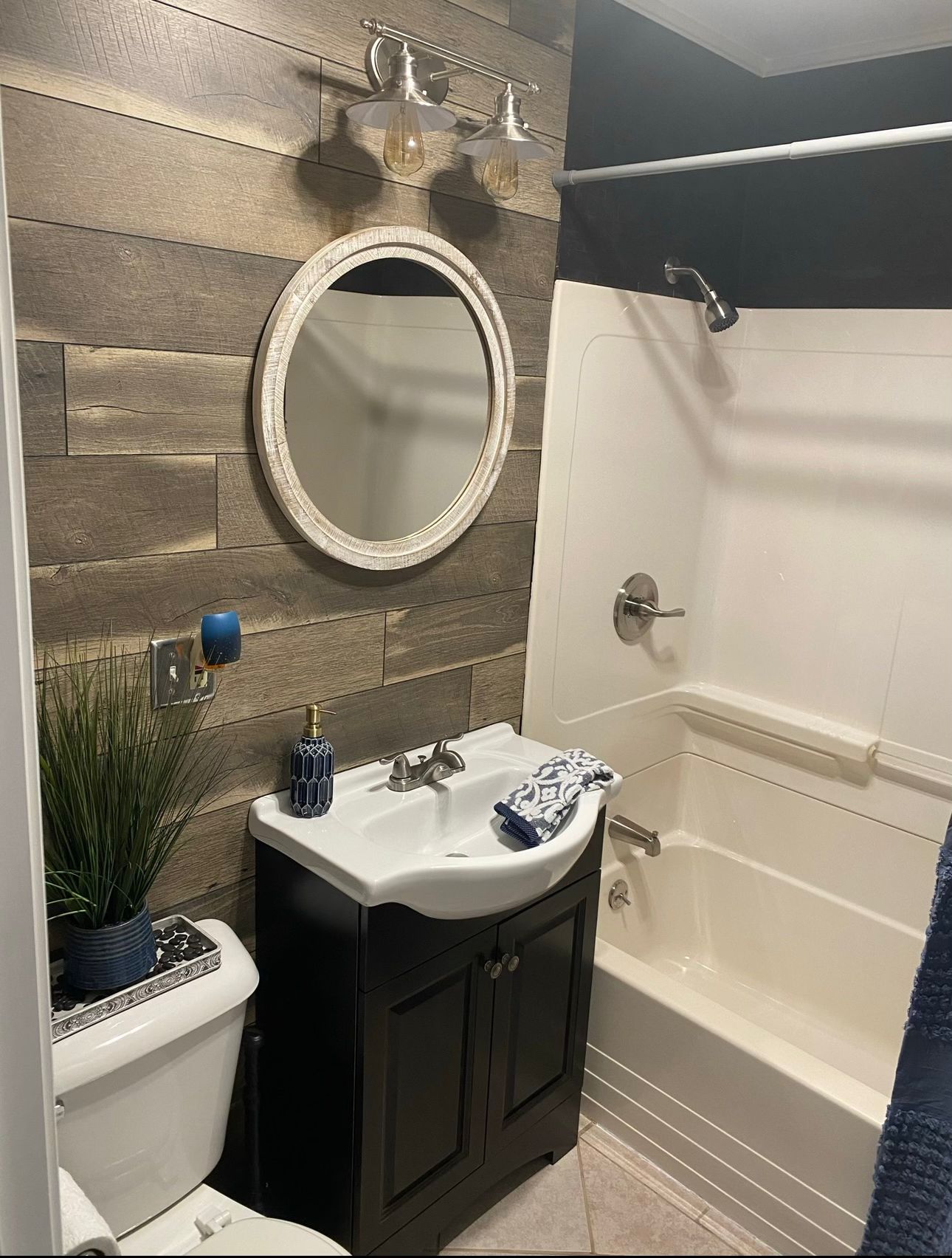 Modern bathroom renovation with wood-grain accent wall and contemporary vanity