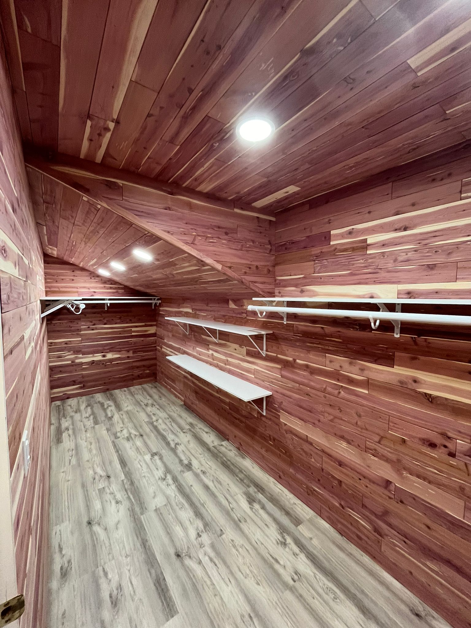 Custom cedar walk-in closet with white shelving systems