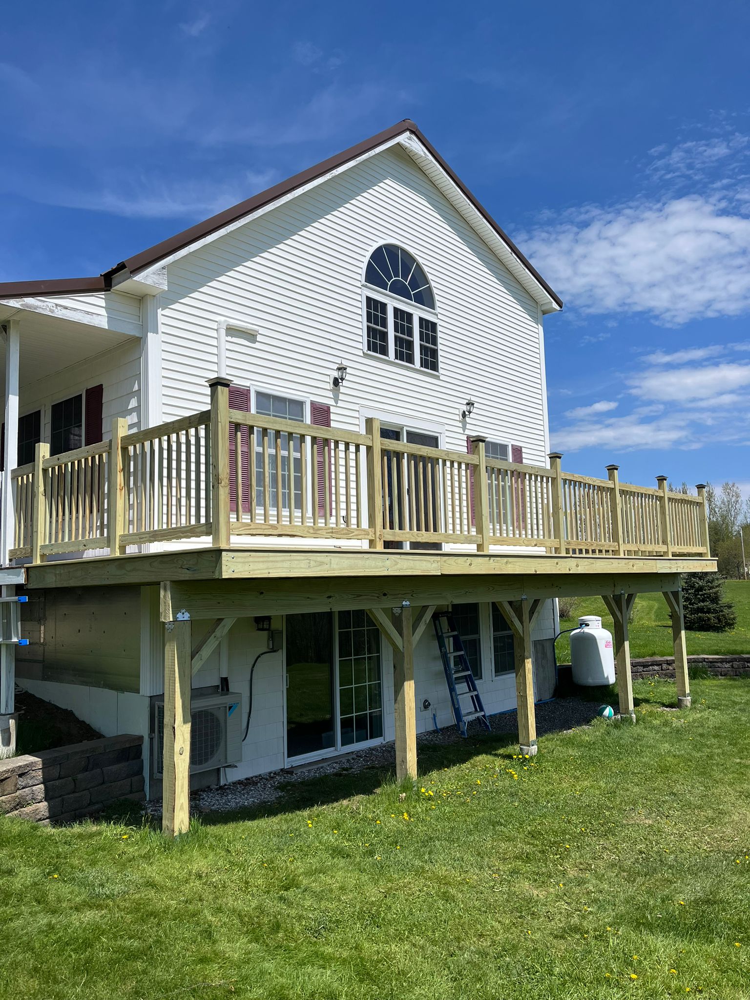 Two-story deck construction with custom railings and support posts