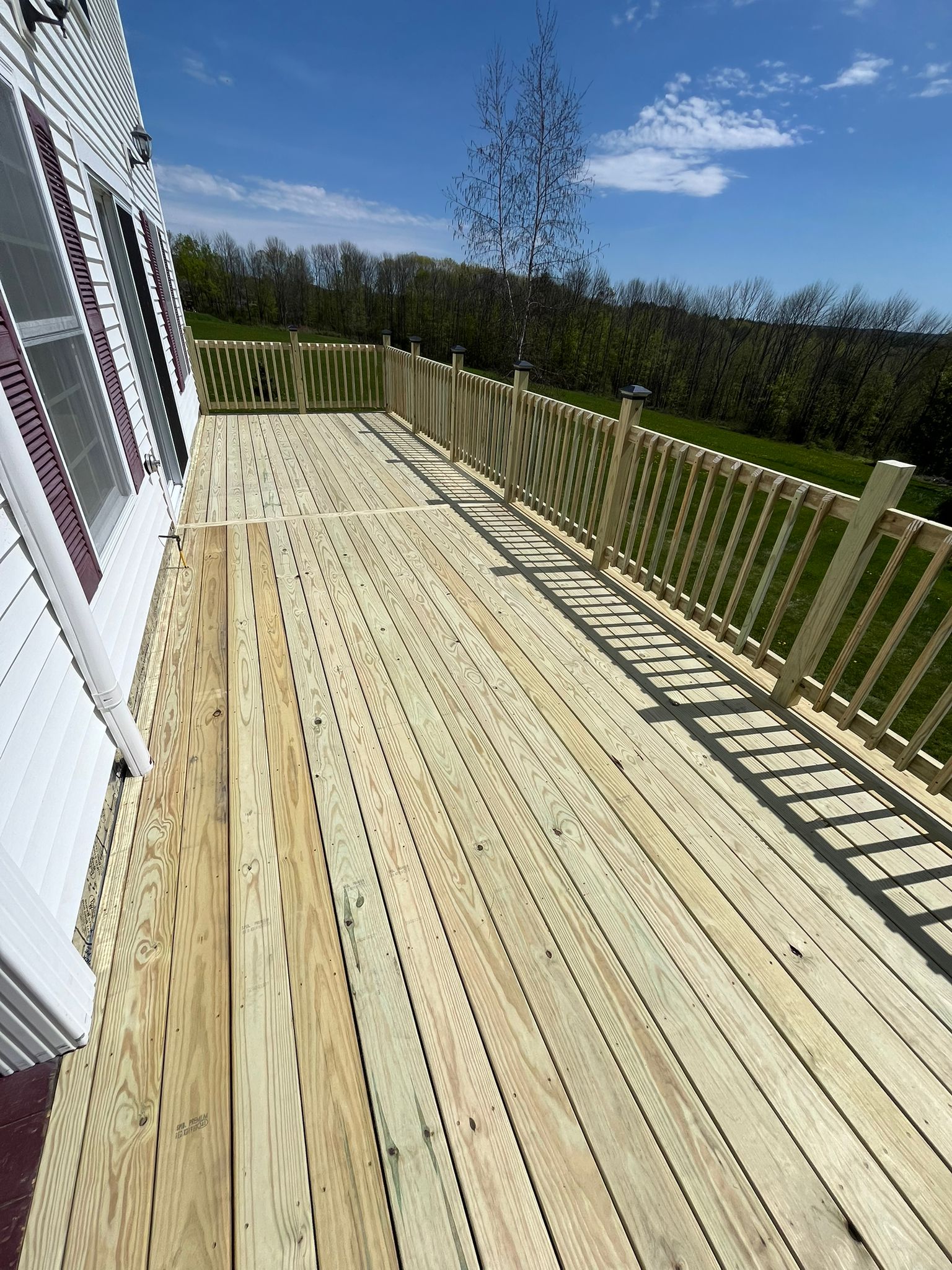 Beautifully finished deck surface with quality wooden planking and railings