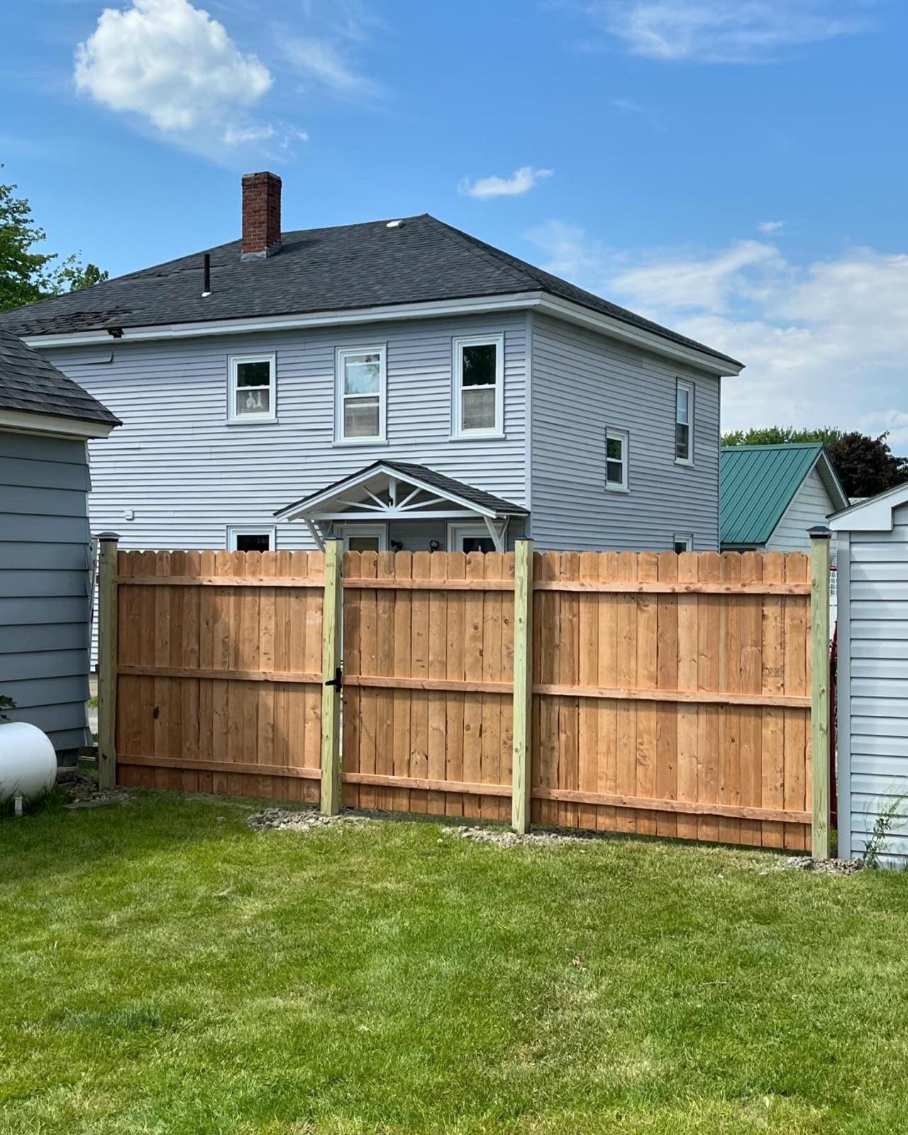 Custom cedar privacy fence with horizontal boards and steel posts