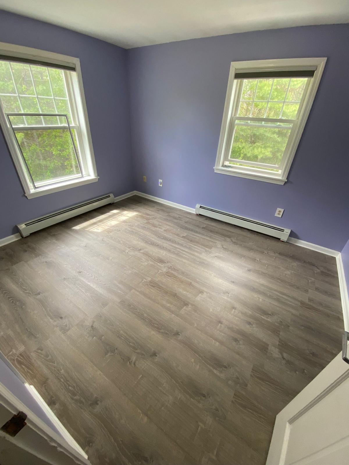 After - Beautiful finished luxury vinyl flooring in purple-walled room