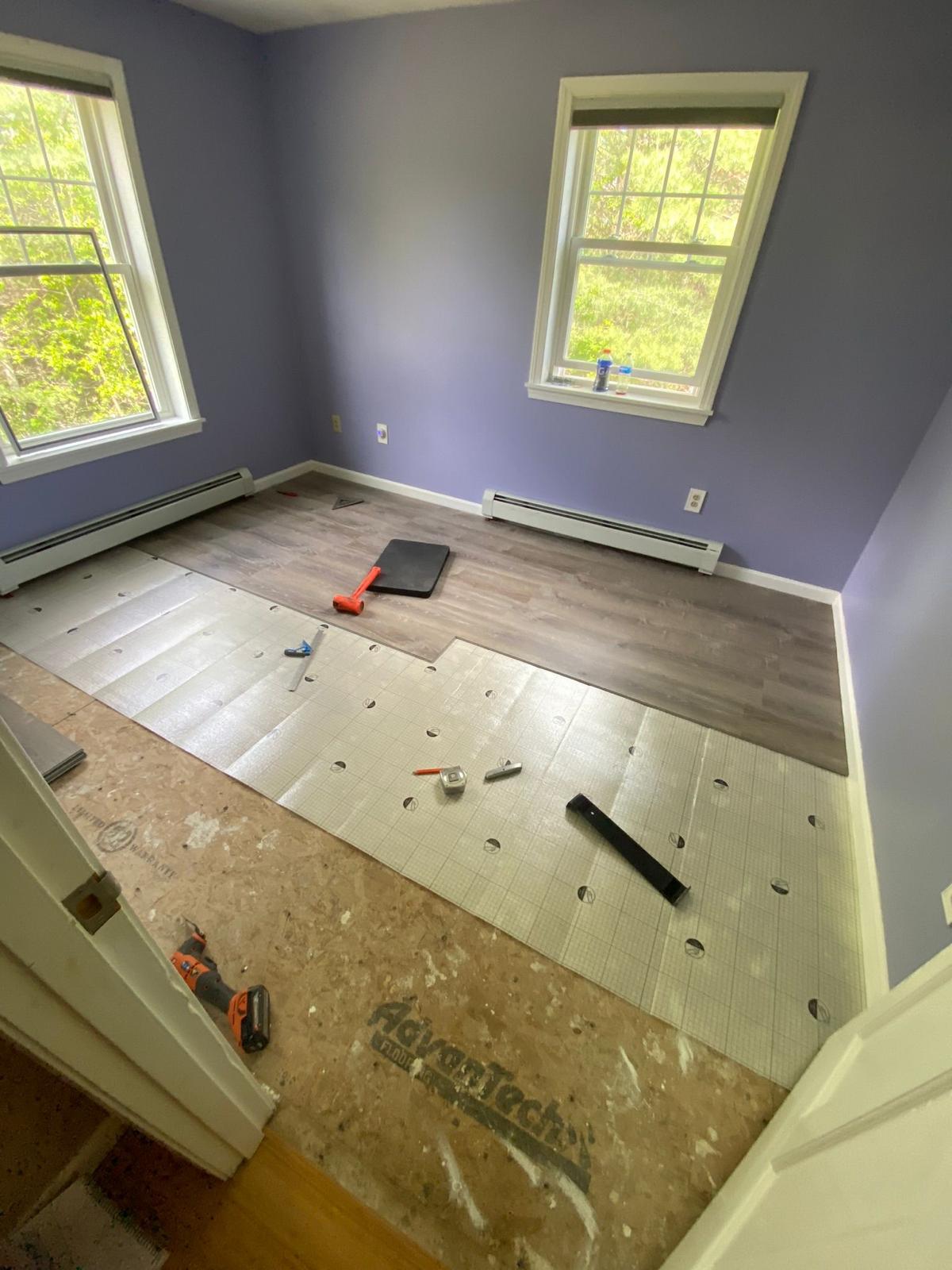 Before - Room during flooring installation with subflooring visible