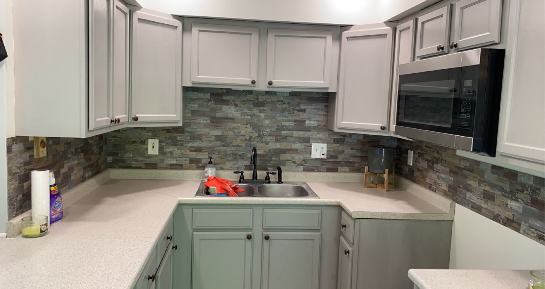 Modern kitchen with painted cabinets and stone tile backsplash