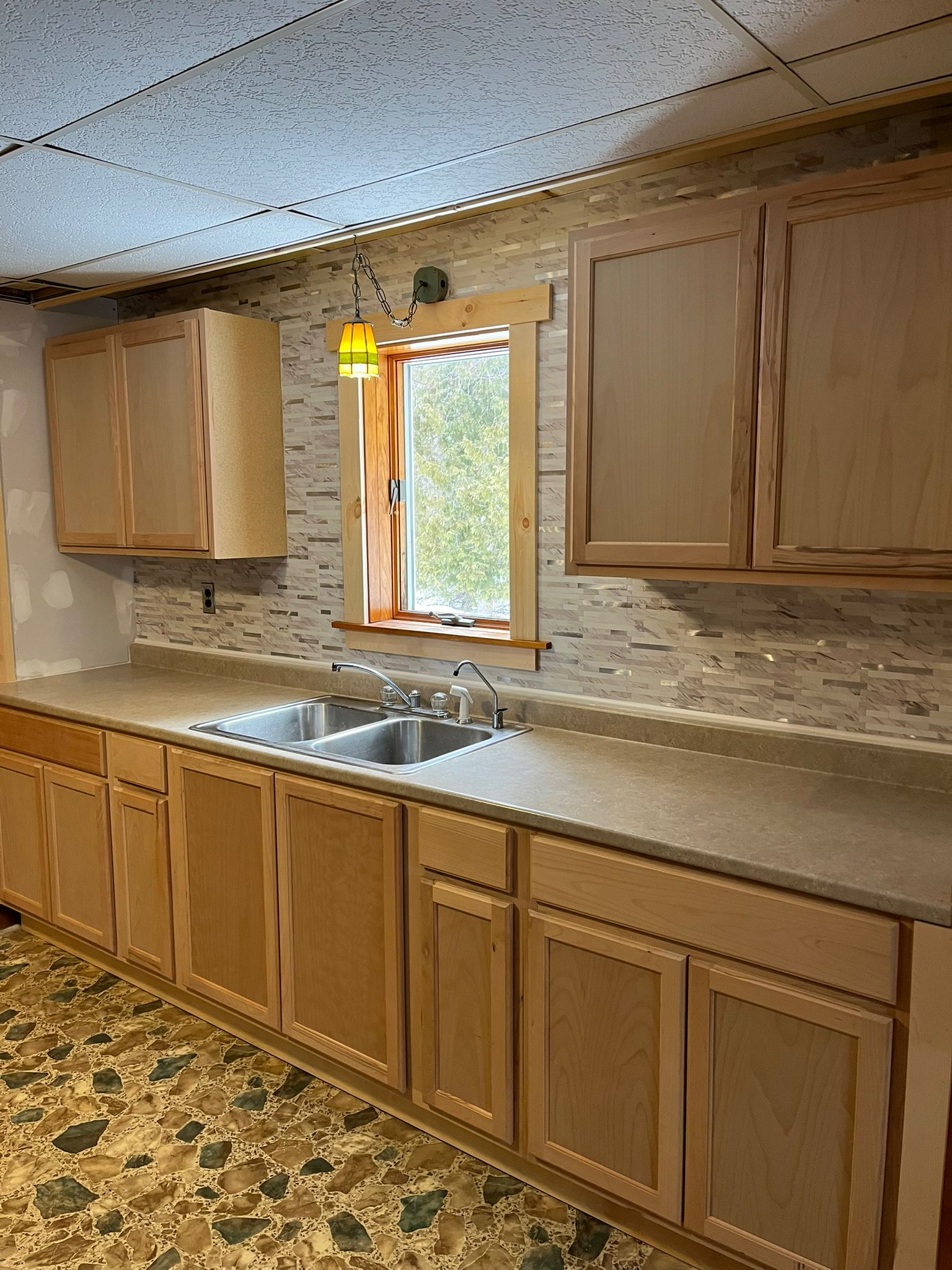 Additional view of kitchen with stone backsplash and custom oak cabinetry